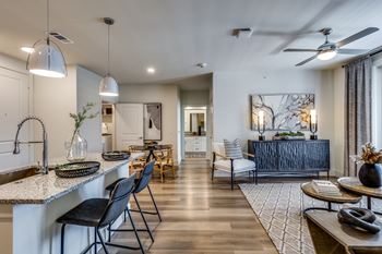 Wood-style flooring in living, dining, and bath areas